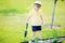 Cute toddler boy working in the garden, squash plants