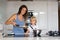 Cute toddler child and mom, mother and blond boy, making pancake in kitchen