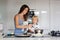 Cute toddler child and mom, mother and blond boy, making pancake in kitchen