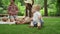 Cute toddler falling on grass in park. Family spending weekend together