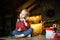 Cute toddler girl eating chocolate egg sitting in a hunting house decorated for Christmas. The concept of a Christmas morning.