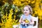 Cute toddler girl enjoying easter egg hunt in garden