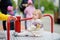 Cute toddler girl having fun on outdoor playground. Baby rides on carousel. Kindergarten, daycare for small children. Equipment