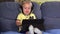 Cute toddler girl with headphones using tablet and listening to music