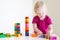 Cute toddler girl plaing with colorful blocks