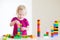 Cute toddler girl plaing with colorful blocks