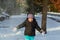 Cute toddler girl in warm snowsuit playing with a snow.