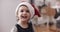Cute toddler girl wearing a Santa hat.
