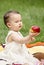 Cute toddler giving an apple