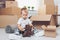 Cute toddler helping out packing boxes