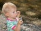 Cute Toddler Holding Rocks At Beach