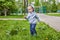 Cute toddler playing on the playground in spring sunny day.handsome boy plucked a dandelion.