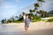 Cute toddler running on a tropical beach