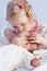 Cute Toddler sister kisses newborn