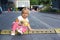 Cute toddler sit on road hump