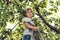 Cute toddler standing on a ladder and wearing cherries on his ears