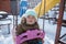 cute toddler swinging in the playground cover with snow