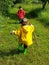 Cute toddlers running on farm road with stick