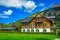Cute traditional alpine wooden house with flowery backyard, Austria