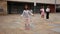 Cute tween African American girl skipping rope in schoolyard during break between lessons
