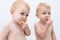 Cute twin boys toddler baby tasting new food lime slices.