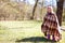 Cute twin sisters wrapped in check plaid. Colorful autumn park