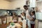 Cute twins feeling lovely while meeting father in the kitchen