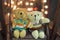 Cute two doll bears. Pair of cute teddies are sitting on wood swing with bokeh light in background. Teddies wear winter suite. Hug