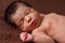 Cute two weeks old newborn baby girl without clothes, or, sleeping