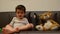 Cute two years old boy watching tv with his teddy bear