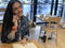 Cute, urban girl sitting in cafe, reading  a book