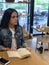 Cute, urban girl sitting in cafe, reading  a book