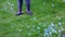 Cute view of child figure plying with colorful bubbles on green lawn.