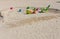 Cute view of colorful sand toys on sandy beach. Family tourism concept