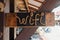 Cute vintage sign of a wi-fi from a rope in black wooden signboard in.