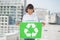 Cute volunteer woman holding recycling sign