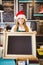 Cute waitress holding a blackboard