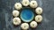 Cute white Baby boo mini pumpkins placed in circle with blue ceramic bowl in the middle