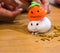 Cute White Winter White Hamster House Pet wearing Halloween Knit Jack O Lantern Pumpkin Party Hat eating pet snack food in