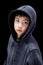Cute Wide-Eyed Asian Boy in Hoodie Isolated on Black
