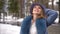 Cute woman in blue coat and hat in winter. High quality FullHD footage