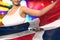 Cute woman holds Dominican Republic flag in front on the party lights - flag concept 3d illustration