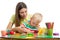 Cute woman and kid boy playing plasticine toys at home