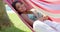 Cute woman laying back in hammock
