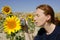 Cute woman photographer in nature sunflower field
