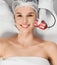 Cute woman on procedure cleaning or massage for face.