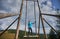 Cute woman resting on giant swing in the mountains.