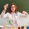 Cute woman scientist with chemical flask and funnel for liquid in hand. Scientific tests and research in the school laboratory