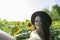 Cute woman with sensuality taking selfie with smart phone on sunflower field. Caucasian lady