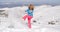 Cute woman in skiing clothes kicking snow